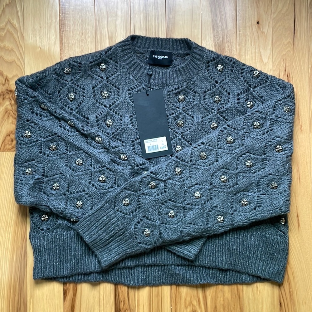 Cable knit crew neck sweater.